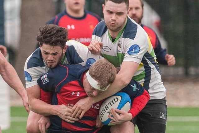Oli Bowles is tackled by two New Milton players. Picture: Keith Woodland