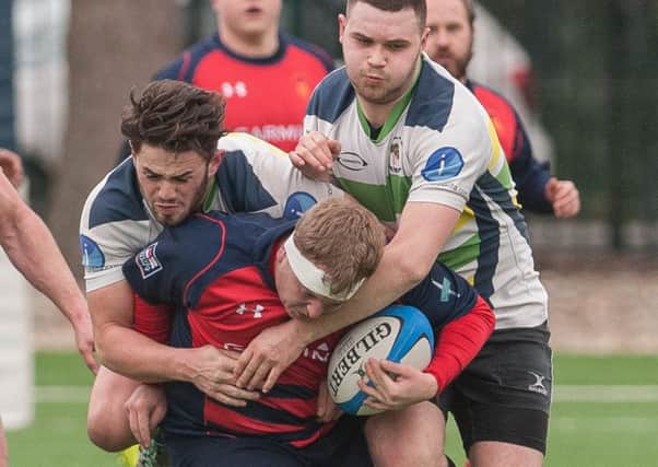 Oli Bowles is tackled by two New Milton players. Picture: Keith Woodland