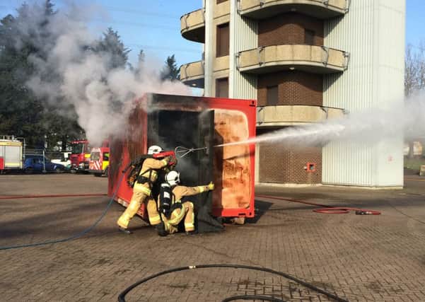 Watch managers Tim Gray and Rob Jenks demonstrate the new high-pressure lance to be brought in as part of changes to Hampshire Fire and Rescue Service