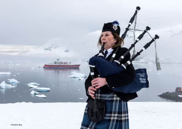 Irene Robinson, a piper who is travelling 50,000 miles to play 12 gigs at famous locations around the world in aid of charity, as she played a unique concert in Paradise Bay, Antarctica.Picture: Renato Granieri/RNRMC/PA Wire