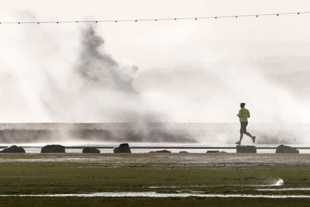 A jogger braves stormy weather along Southsea seafront. Picture: Shaun Roster www.shaunroster.com