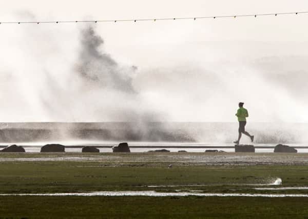 A jogger braves stormy weather along Southsea seafront. Picture: Shaun Roster www.shaunroster.com