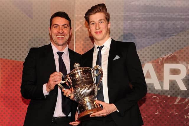 Joe Truman accepts one of his trophies from Jason Queally, left, at British Cycling's annual awards ceremony. Picture: British Cycling