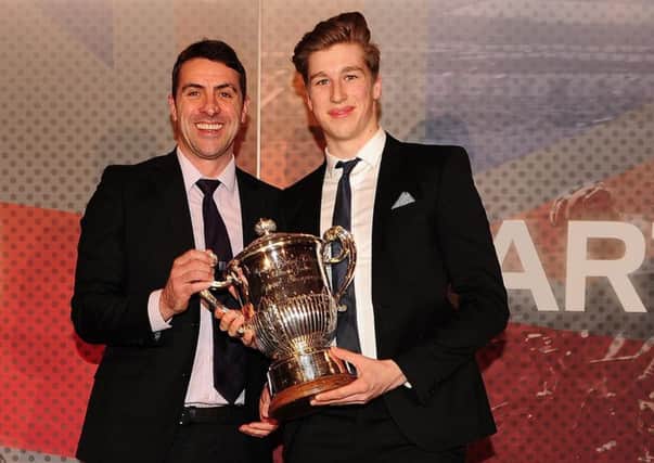 Joe Truman accepts one of his trophies from Jason Queally, left, at British Cycling's annual awards ceremony. Picture: British Cycling