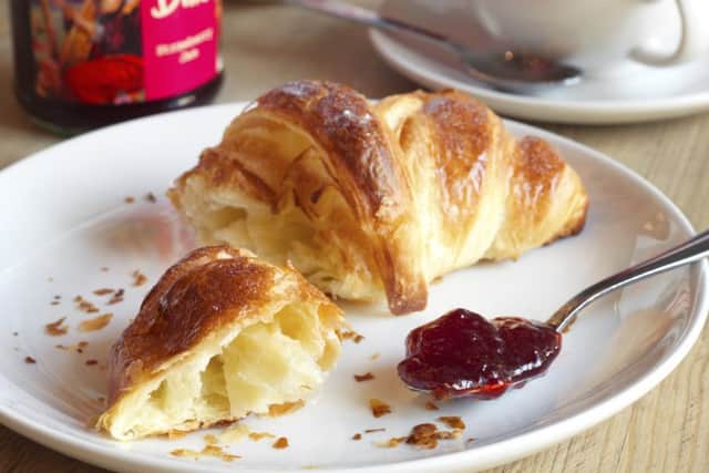 Emma loves a piece of croissant smeared in jam