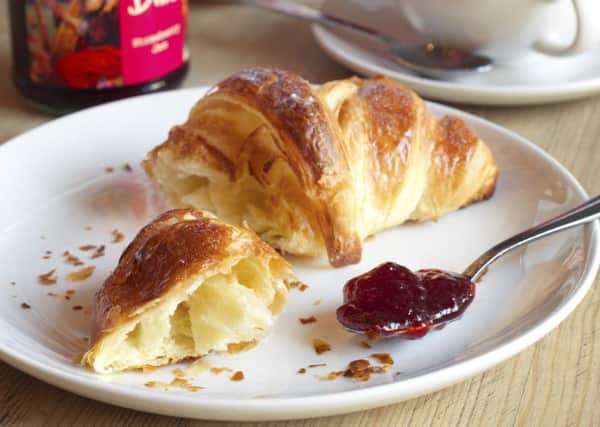 Emma loves a piece of croissant smeared in jam