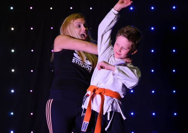 Harvey Griffiths, nine, demonstrates judo moves with the help of Sarah Smith of Same Difference at SD Studios in Portsmouth