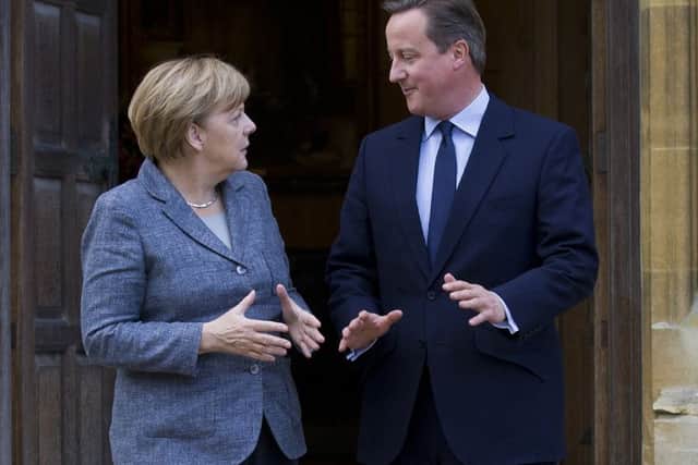 Prime Minister David Cameron talks to German Chancellor Angela Merkel