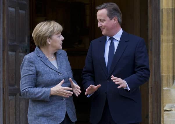 Prime Minister David Cameron talks to German Chancellor Angela Merkel