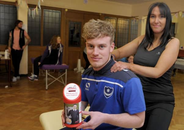 Pompey player Dory Yates gets a massage from event organiser Helena Murphy at the 
Walking with the Wounded  fundraiser 

Picture: Paul Jacobs (160141-5)