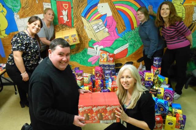 Canon Bob White, vicar of St Marys, Fratton, delivering the Easter eggs to Mel Goddard, family services manager for the Roberts Centre in Portsmouth after last years appeal.