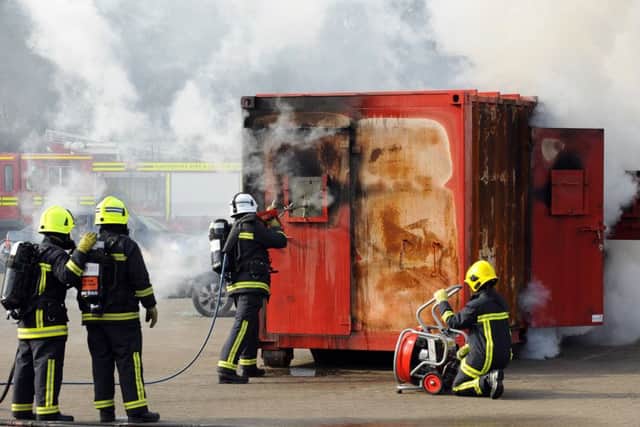 A fire crew demonstrates the use of new equipment