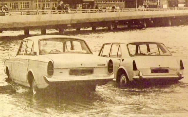 OOPS! Two cars about to be overcome by the tide on the slipway off the Hard in 1970