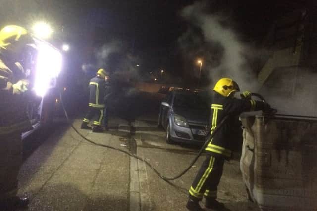 A crew from Fareham Fire Station put out fires in two commercial wheelie bins. Picture: Hampshire Fire and Rescue