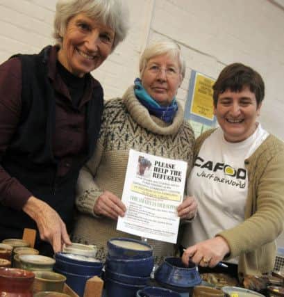From the left are Jackie Stott, Janet Hind and Maureen Thompson with ceramics from the Hole in the Wall Community Potters