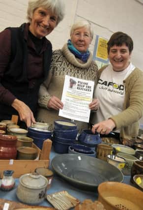 From the left are Jackie Stott, Janet Hind and Maureen Thompson with ceramics from the Hole in the Wall Community Potters