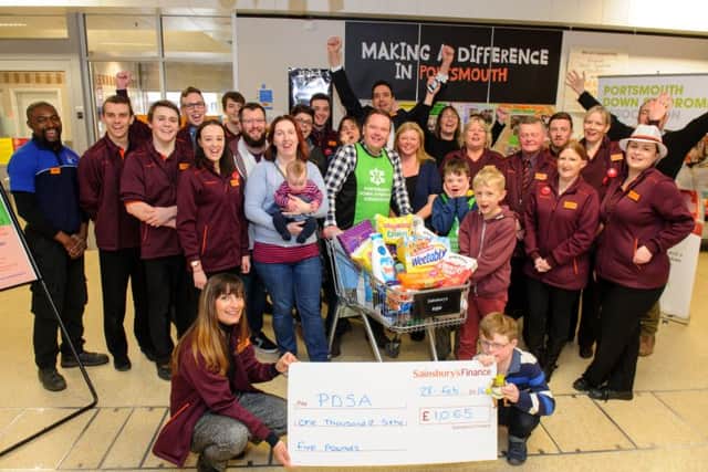 Andy Ford (in green) after his trolley dash through Sainsbury's and a cheque for the PDSA Picture: Allan Hutchings (160377-402)