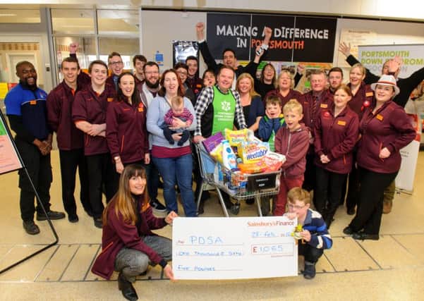 Andy Ford (in green) after his trolley dash through Sainsbury's and a cheque for the PDSA 

Picture: Allan Hutchings (160377-402)