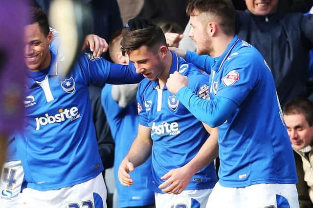 Marc McNulty, right, celebrates his goal against Cambridge United with Conor Chaplin, centre, and Kyle Bennett Picture: Joe Pepler