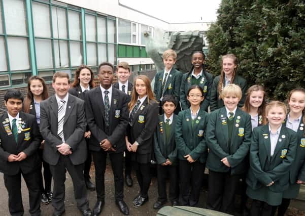 St Edmund's Catholic School in Portsmouth, has received a 'outstanding' Ofsted report. Headteacher Simon Graham is pictured with students at the school 
Picture: Sarah Standing (160462-5528)