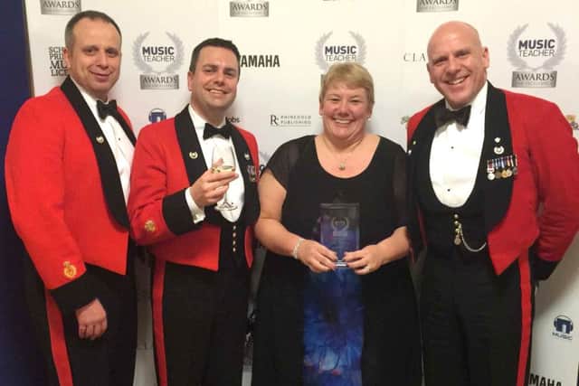 Portsmouth Music Hub CEO Sue Beckett with members of the Royal Marines Band Service, a hub partner, at the ceremony in London
