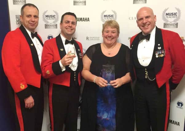 Portsmouth Music Hub CEO Sue Beckett with members of the Royal Marines Band Service, a hub partner, at the ceremony in London
