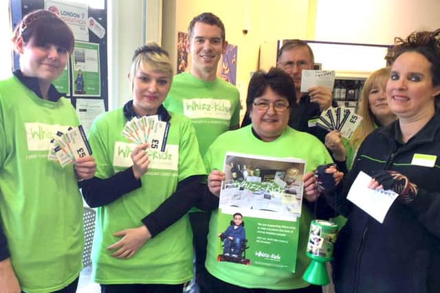 Garry Farne, Manager of The Southern Co-operative store in Emsworth (centre back) and his store colleagues with a small selection of the prizes available