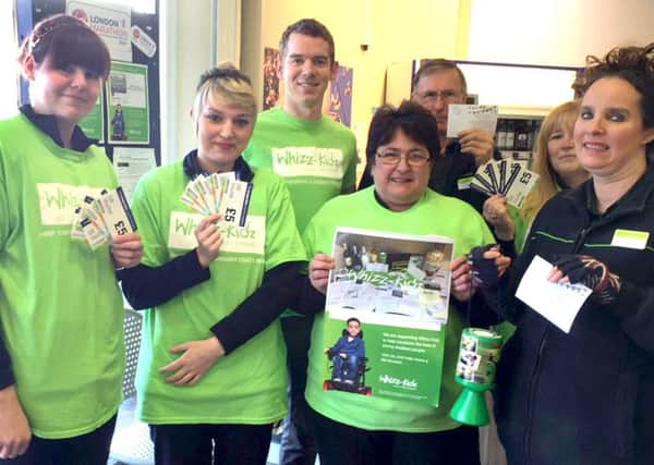 Garry Farne, Manager of The Southern Co-operative store in Emsworth (centre back) and his store colleagues with a small selection of the prizes available