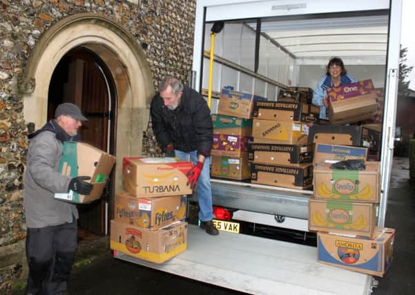 From left: Bill Woods, David Rance and Sally Adams pack the van outside St James Church, Emsworth
