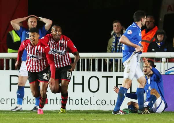 Pompey players can't hide their frustration as Ollie Watkins celebrates his late leveller. Picture: Joe Pepler