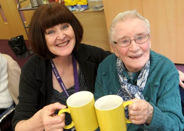Fareham Saturday Friends club members celebrate the club's first birthday at Fareham Library - Assistant library manager Mandy Watmough, left, shares a drink with Sheila Leader from Havant, who at 91 is the oldest member.  
Pic: Mick Young