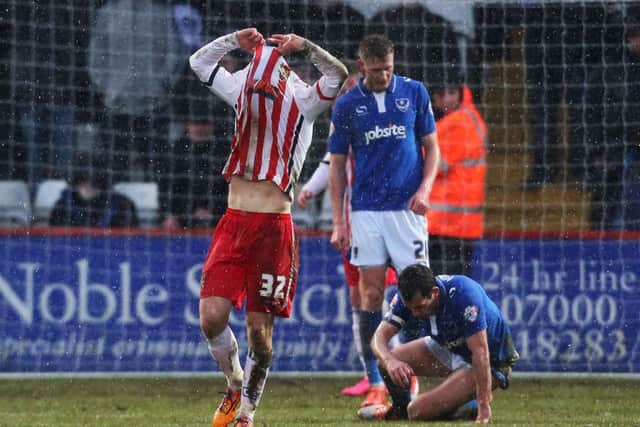 Stevenage midfielder Tom Conlon buries his head in his shirt after seeing his shot hit the crossbar in stoppage-time during his side's 2-0 loss to Pompey Picture: Joe Pepler
