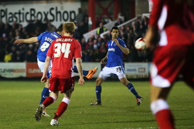 Skipper Michael Doyle volleys home Pompey's third goal at Accrington. Picture: Joe Pepler