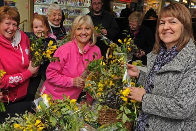From left, Val Hockley and her granddaughter Ellie Hockley, five, with Sandy Mitchell serving customer Tracy Gilgallon from Fareham Picture Ian Hargreaves (160342-2)