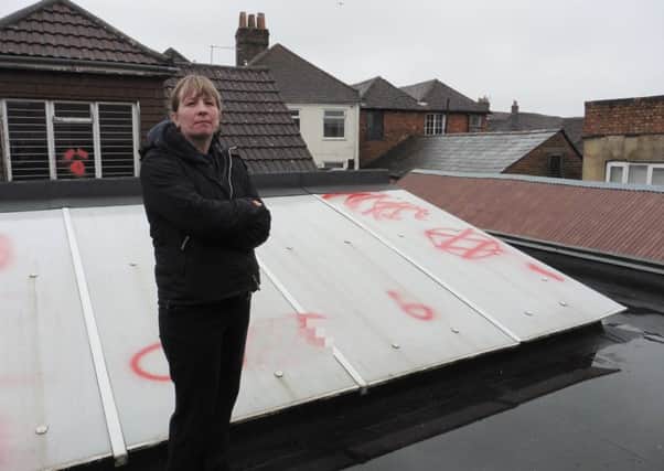 Carol Hunt, shop manager of Forces Suport in Fareham, who is angry after obscene graffiti was sprayed on the roof of her shop



Picture: Olivia Meades