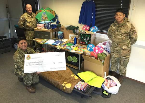 GENEROSITY From left: Private Rai Bikram, Corporal Mark Stanley and Private Rai Lawahang with the items collected 							                    Picture: Mark Stanley