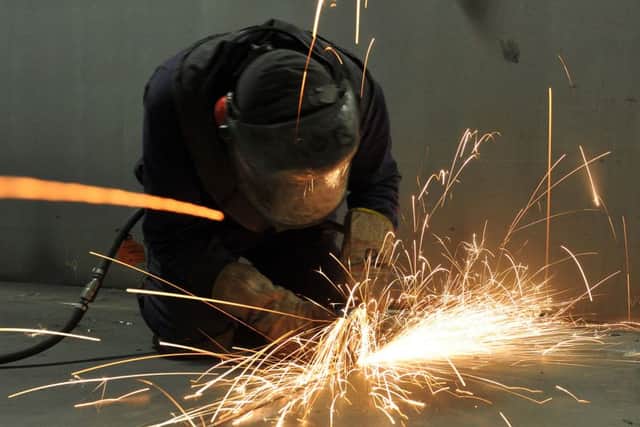 A fitter cutting steel inside the C ring of the HMS Queen Elizabeth carrier in Portsmouth in 2011