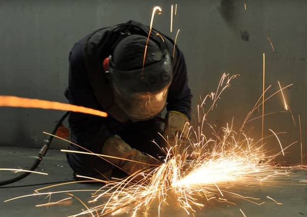 A fitter cutting steel inside the C ring of the HMS Queen Elizabeth carrier in Portsmouth in 2011