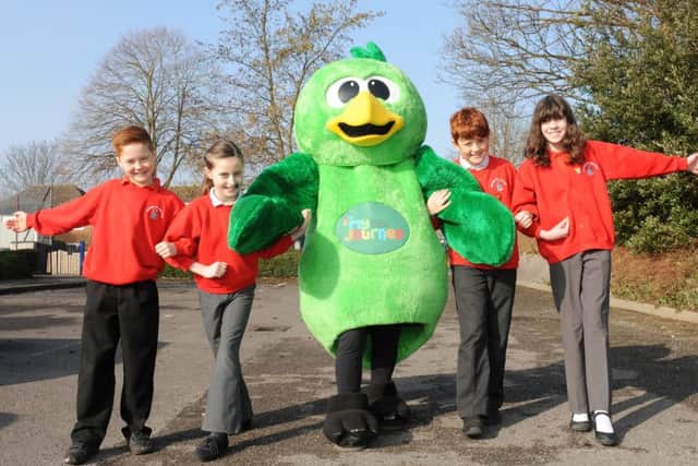 Basil Bird with (l-r) Oliver Giles (9), Tilly Dobson (10), Sam Redington (11) and Marie Noble (10) walking into Alverstoke school. Picture: Sarah Standing (160510-7060)