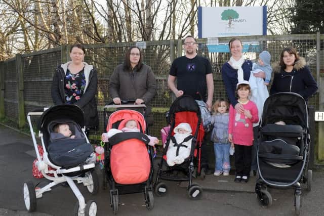 Parents from Gosport and Fareham (l-r) Gemma Blanks (32), Kirsty Wilson (32), Adam Darby (31), Rosalyn Fawcett (33) and Leanda Woodward (32) with their children outside The Haven Sure Start centre in Gosport.