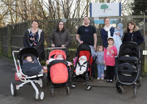 Parents from Gosport and Fareham (l-r) Gemma Blanks (32), Kirsty Wilson (32), Adam Darby (31), Rosalyn Fawcett (33) and Leanda Woodward (32) with their children outside The Haven Sure Start centre in Gosport.