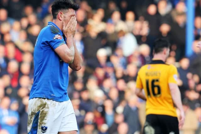 Gary Roberts holds his head in his hands after being sent off against Newport County Picture: Joe Pepler