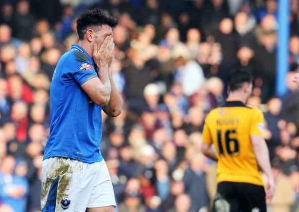 Gary Roberts holds his head in his hands after being sent off against Newport County Picture: Joe Pepler