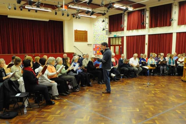 A library picture of Portdmouth Festival Choir as they practise in City of Portsmouth Girls' School - with Andrew Cleary conducting