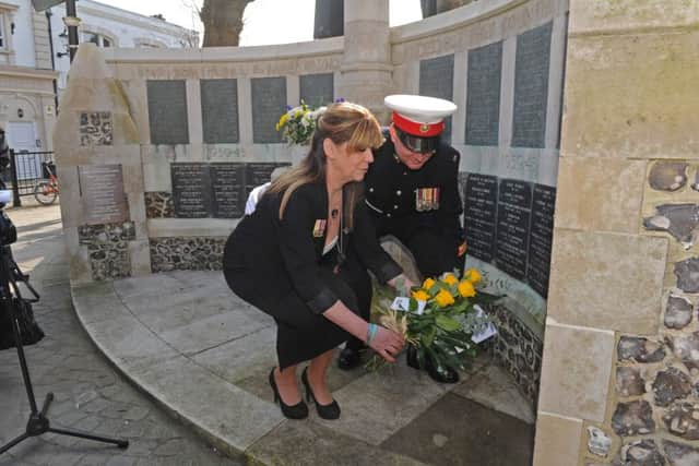 Rosemary Turner lays a wreath to her son Royal Marine David O'Connor with David's friend Rian Ilett
