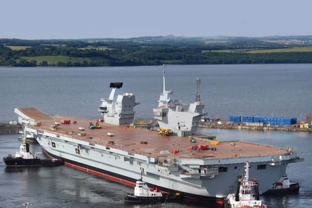 HMS Queen Elizabeth is floated out of her dock for the first time in Rosyth last year