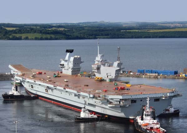 HMS Queen Elizabeth is floated out of her dock for the first time in Rosyth last year