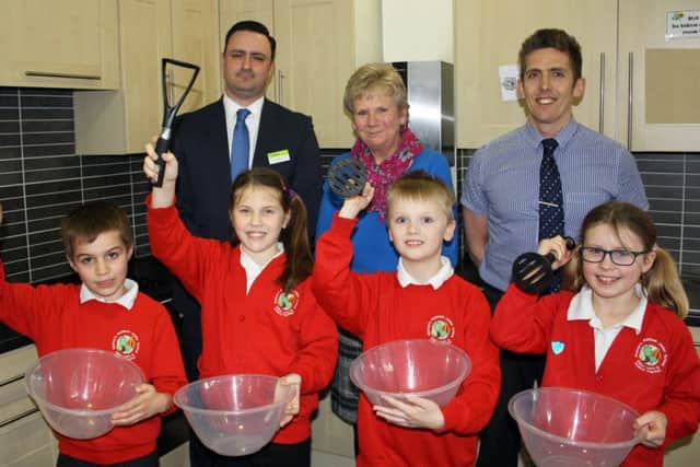 Back row L-R: Mark Mullan, Area Business Manager for The Southern Co-operative; Davina Tibbetts, Home Economist; and Darren Campbell, Head Teacher for Bishops Waltham Junior School.Front row L-R: Aidan Dunsmore, Evie Bailey, Aiden James and Devon Cooper