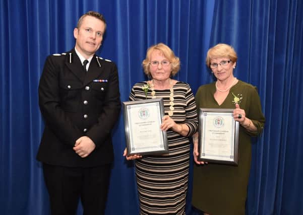 BRAVE: Linda Yorke, left, with  Patricia Fatherly, right, being presented with their bravery awards   Photo: Jan Brayley