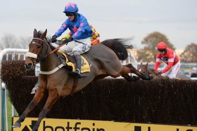 Cue Card and Joe Tizzard on their way to victory in the Betfair Chase during the Betfair Chase Festival at Haydock Park Racecourse, Newton-le-Willows.